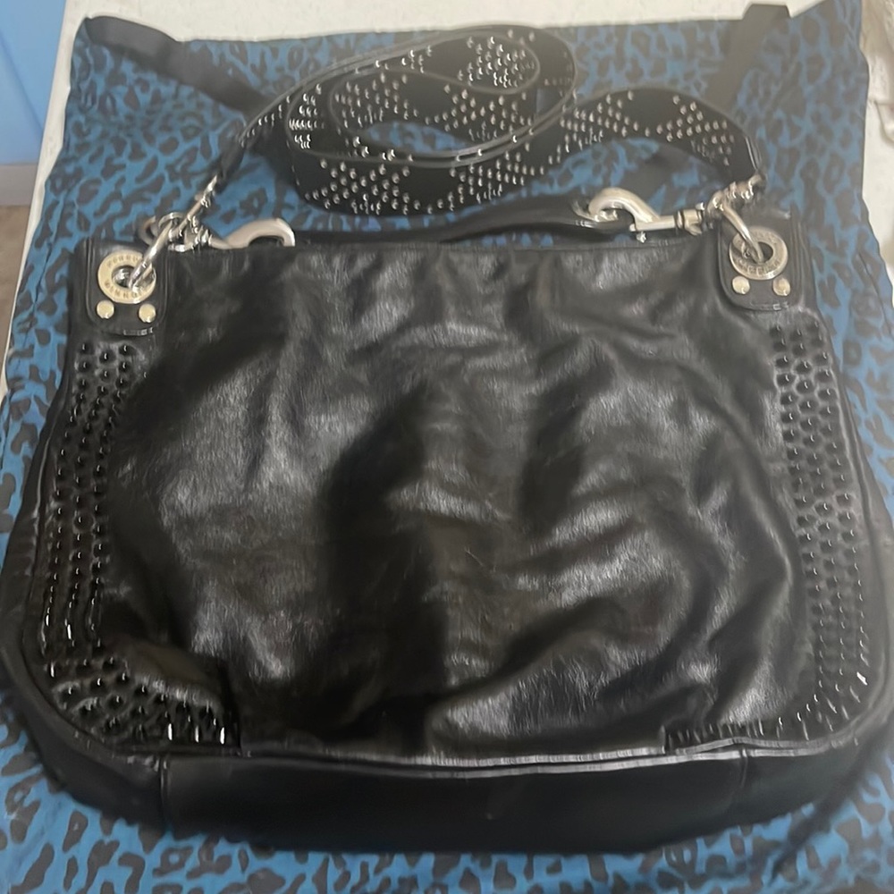 Leather Rebecca Minkoff bag with studded guitar strap.